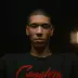 a man in a black shirt is posing for a picture